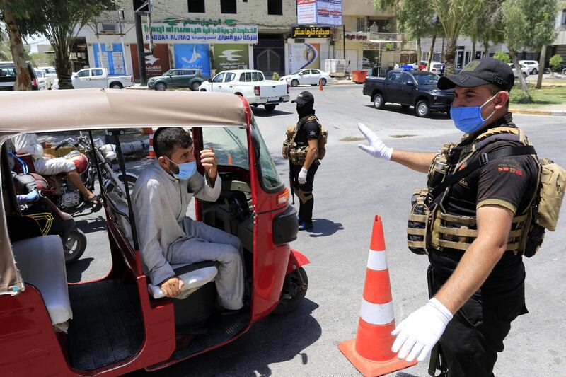 Iraqi policemen stand at a checkpoint during curfew in Karbala, south of Baghdad, Iraq.  EPA