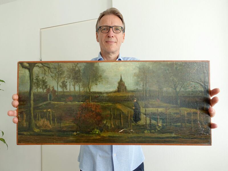 Dutch art detective Arthur Brand poses with Vincent van Gogh's Parsonage Garden at Nuenen in Spring painting. AFP