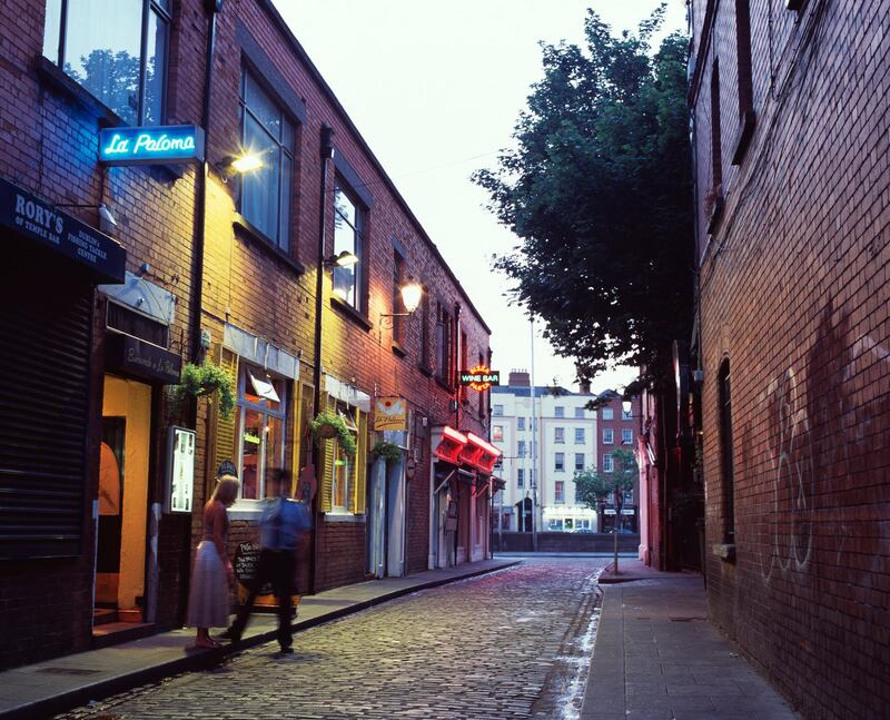 Man and woman talking in an alleyway in Dublin, Ireland. Getty Images