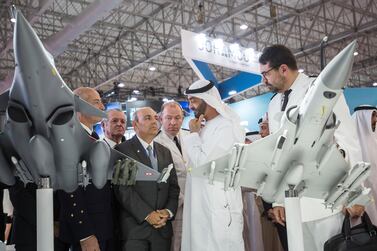 Sheikh Mohammed bin Zayed - once a pilot in the UAE Air Force - visits a manufacturer's stand on the opening day of the Dubai Airshow. Leslie Pableo for the National