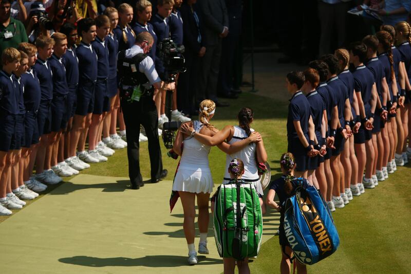 LONDON, ENGLAND - JULY 06:  Marion Bartoli of France and Sabine Lisicki of Germany leave the court arm-in-arm after their Ladies' Singles final match on day twelve of the Wimbledon Lawn Tennis Championships at the All England Lawn Tennis and Croquet Club on July 6, 2013 in London, England.  (Photo by Julian Finney/Getty Images) *** Local Caption ***  173071611.jpg