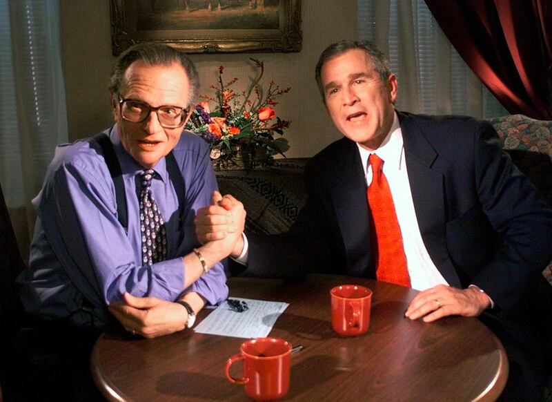 Texas Governor and Republican presidential candidate George W Bush jokes with Larry King after taping an interview at the Wildhorse Saloon in Nashville, Tennessee on December 16, 1999. AP Photo
