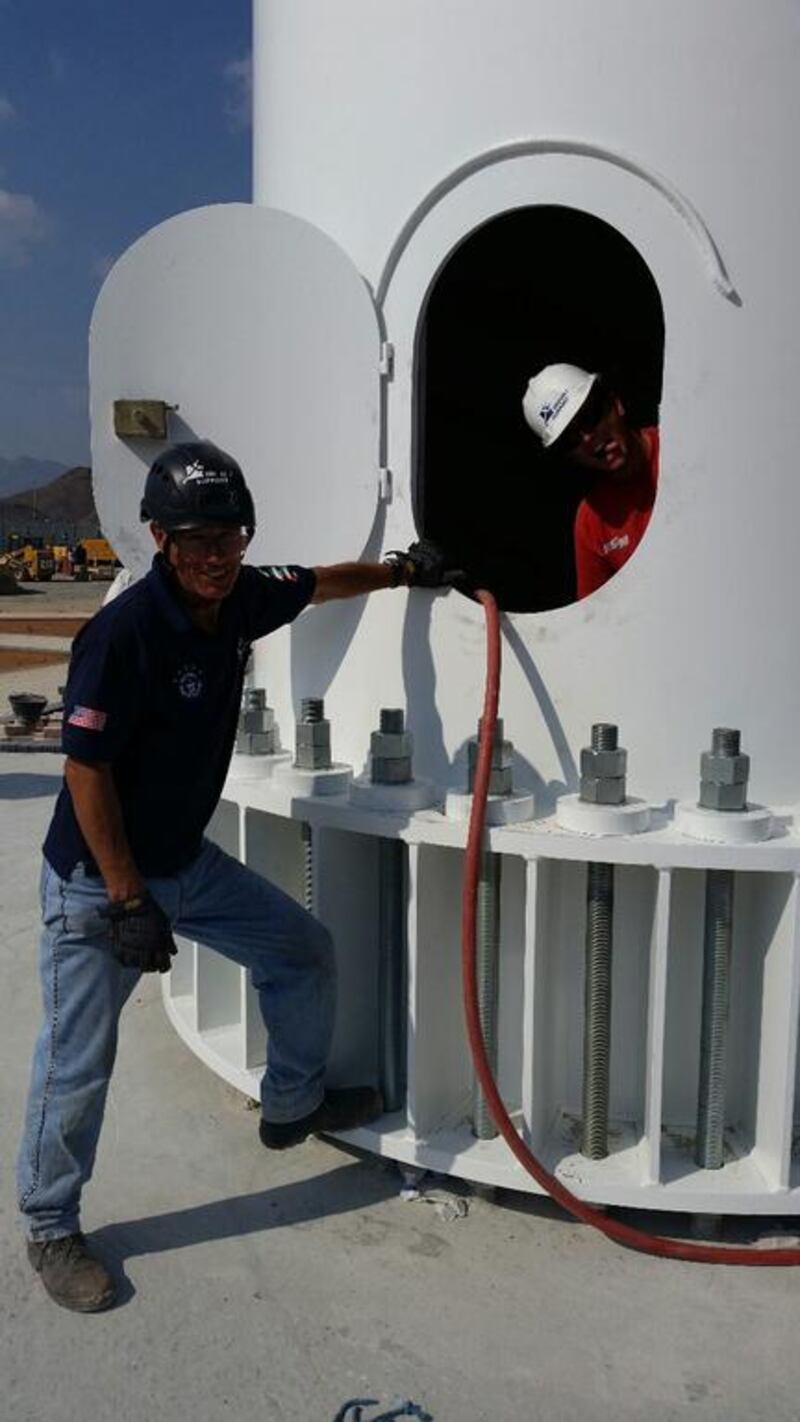 The Trident Support team work on erecting the two new flagpoles in Fujairah and Umm Al Quwain.