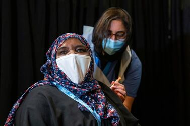 A woman is vaccinated at a London mosque. AP