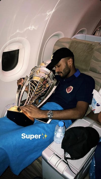 Ahmed Al Akberi with the Super Cup they won against Al Ain on the flight back from Egypt.