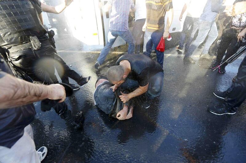 A civilian beats a soldier after troops involved in the coup surrendered on the Bosphorus Bridge in Istanbul (REUTERS/Murad Sezer)