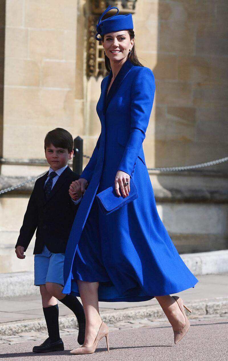 Catherine, Princess of Wales, in a blue Catherine Walker coatdress, with her son, Prince Louis, attend the Easter Sunday service at St Georges Chapel at Windsor Castle on April 9, 2023. EPA