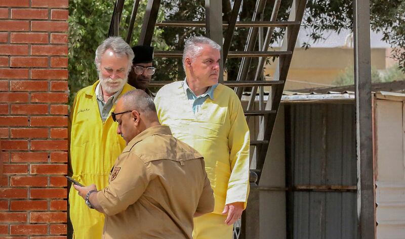 James Fitton, 66, a retired British geologist, left, and Volker Waldmann, 60, a psychologist from Berlin, arrive for their trial in Baghdad in May. AFP