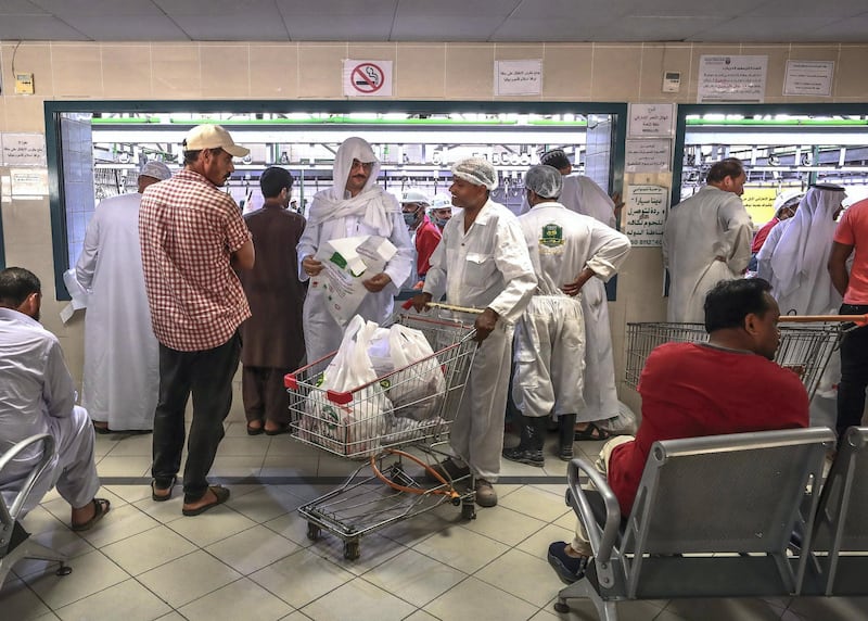 Abu Dhabi, U.A.E., August 22 , 2018.  Livestock shoppers for the second day of Eid Al Adha at the Abu Dhabi Livestock Market and the Abu Dhabi Public Slaughter House (Abu Dhabi Municipality) at the  Mina area.-- Customers waiting for their purchased livestock properly processed by slaughter house workers.
Victor Besa/The National
Section:  NA
For:  stand alone and stock images