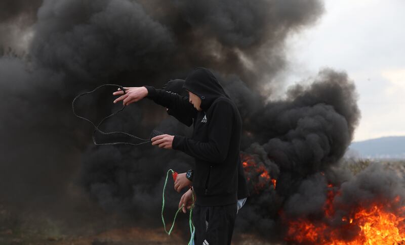 epa09747201 Palestinian protesters clash with Israeli forces during a demonstration against Israel's settlements  on the lands of Beita village, near the West Bank city of Nablus.  EPA