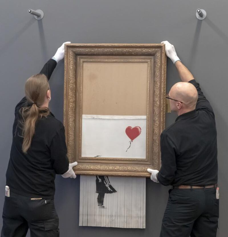 epa07342914 Museum employees hang Banksy's 'Love is in the Bin' artwork at the Frieder Burda Museum in Baden-Baden., Germany, 04 February 2019. The Frieder Burda Museum will be showing from 05 February 2019 to 03 March 2019 to the public for the first time the Banksy work 'Love is in the Bin', acquired by a European collector and auctioned off at Sotheby's in London.  EPA-EFE/RONALD WITTEK