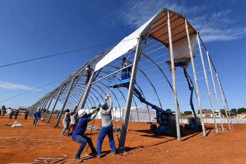 Labourers work at the construction site of a field hospital for people infected with the new coronavirus in Aguas Lindas, Goias State, Brazil.  AFP