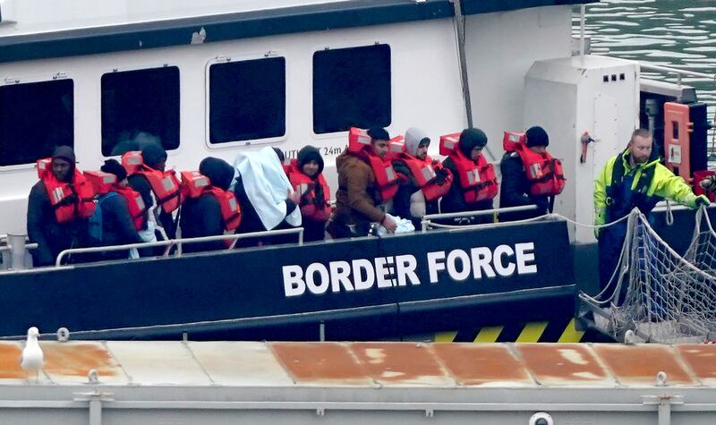 A group of people thought to be migrants are brought in to Dover, Kent. PA