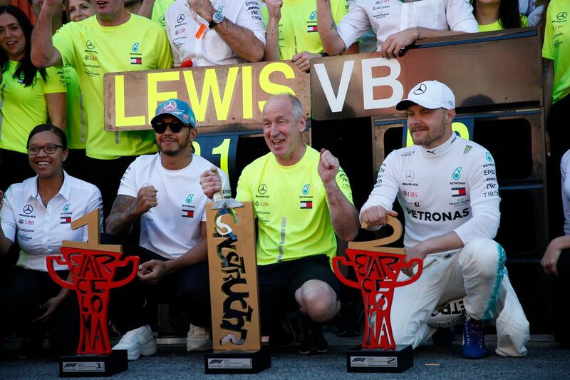 Mercedes drivers Lewis Hamilton of Britain, left, and Valtteri Bottas of Finland, right, celebrate with Mercedes team members after wining the Spanish Formula One race at the Barcelona Catalunya racetrack in Montmelo, just outside Barcelona, Spain, Sunday, May 12, 2019. (AP Photo/Joan Monfort)