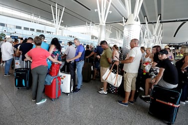 Passengers are seen at Thomas Cook check-in points at Enfidha-Hammamet International Airport, Tunisia. Zoubeir Souissi / Reuters