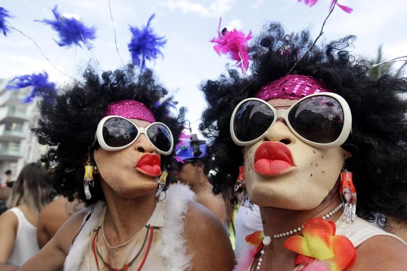 Mask-wearing revellers pose for a photo during the Banda de Ipanema Carnival parade in Rio. Silvia Izquierdo / AP Photo