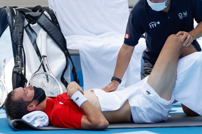 Daniil Medvedev, of the Russian Olympic Committee, has a medical timeout during his men's singles third round match against Fabio Fognini, of Italy, at the Tokyo 2020 Olympic Games.