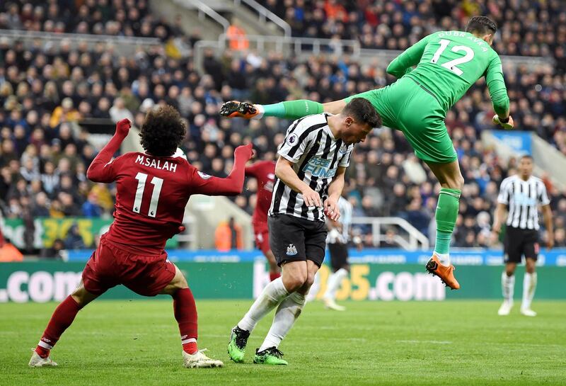 Mohamed Salah of Liverpool picks up an injury as he collides with Martin Dubravka of Newcastle United as they compete for the ball. Shaun Botterill / Getty Images