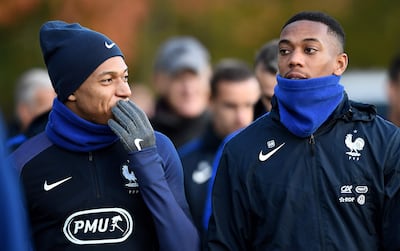 France's forward Kylian Mbappe (L) speaks with forward Anthony Martial before a training session in Clairefontaine-en-Yvelines near Paris on November 7, 2017,  as part of the team's preparation for friendly football matches against Wales and Germany.  / AFP PHOTO / FRANCK FIFE