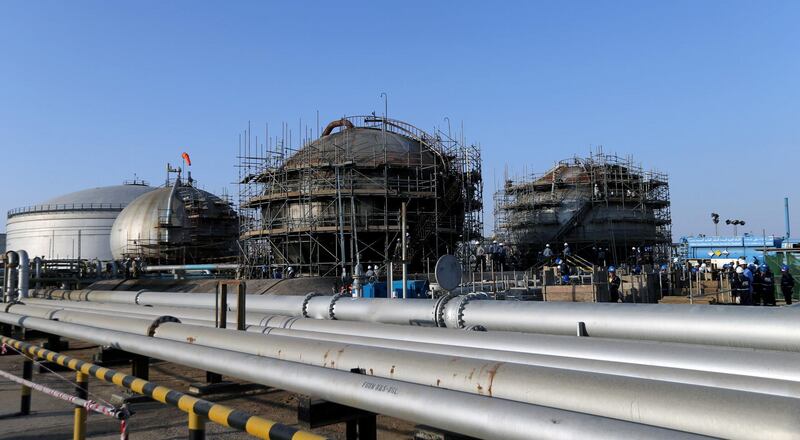 FILE PHOTO: Workers are seen at the damaged site of Saudi Aramco oil facility in Abqaiq, Saudi Arabia, September 20, 2019. REUTERS/Hamad l Mohammed/File Photo