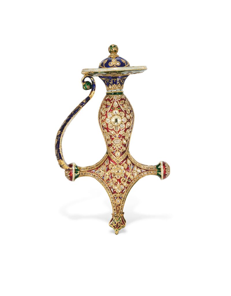 Lot 67 - an enameled and gem-set gold tulwar hilt. Possibly Jaipur, north India, 19th century