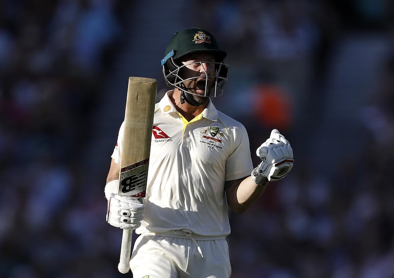 AUstralian batsman Matthew Wade celebrates after reaching his century . Getty