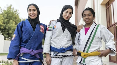 Mahra Al Hanaei, centre, pictured with her fellow athlete sisters, Maha, left, and Hana. Antonie Robertson / The National