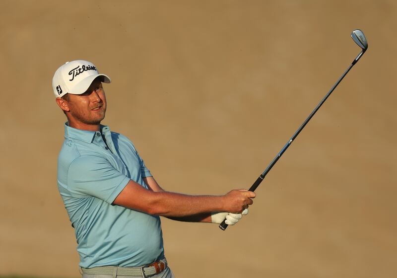 Justin Harding of South Africa plays his approach shot on the 14th hole. Getty