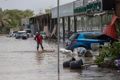 A man stands in a flooded street in Fujairah city. Antonie Robertson / The National
