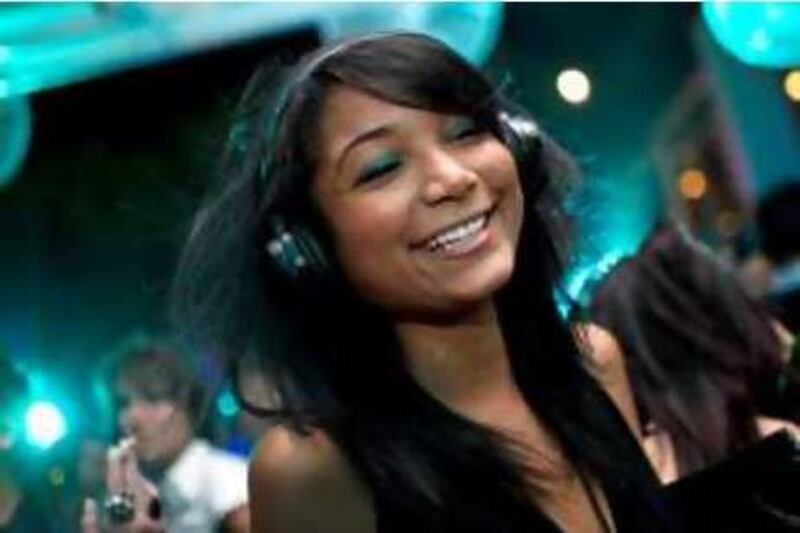 Dubai - November 12, 2008:  Anouchka Lucas Carter, 22, dances during the silent disco at Sho Cho's in the Dubai Marine Beach Resort & Spa  ( Philip Cheung / The National ) *** Local Caption ***  PC0110-SilentDisco.jpg