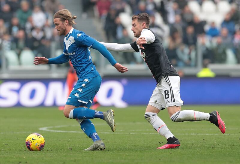 Birkir Bjarnason of Brescia Calcio is challenged by Aaron Ramsey of Juventus. Getty Images