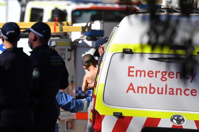 Paramedics take Anthony Elfalak, 3, to an ambulance on September 6, 2021, after three days lost in woodland near his family's property north-west of Sydney, Australia. EPA