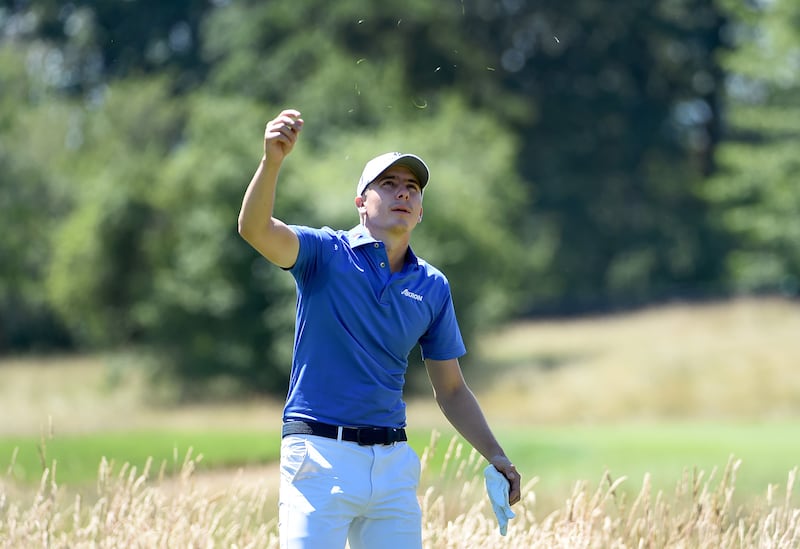 Carlos Ortiz checks the wind on the seventh hole during round two of the LIV Golf Invitational - Portland. Getty
