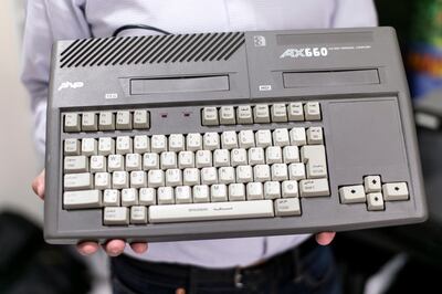 DUBAI, UNITED ARAB EMIRATES, JULY 13, 2016. Rami Al Qaddoumi, founder of the online store retrogamer.ae, holds Sakhr AX660 from his personal collection. Photo: Reem Mohammed / The National (Reporter: Hareth Albustani / Section: AL) ID 45491 *** Local Caption *** RM_20160714_RETROGAMES_10.JPG