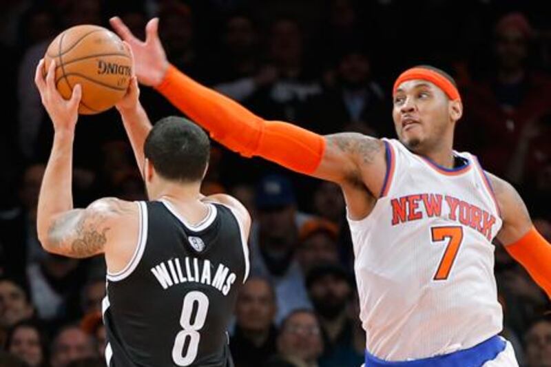 New York's Carmelo Anthony looks to block Brooklyn Nets guard Deron Williams.