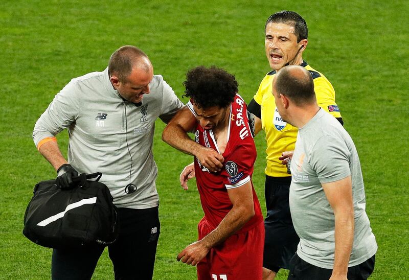 Salah and the Liverpool physio take a look at the damage. Robert Ghement / EPA