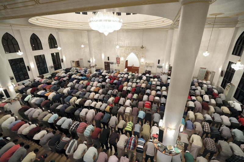 Dubai, United Arab Emirates - May 16, 2019: People pray after Iftar. Mosque series for Ramdan. Lootah Masjid Mosque is an old mosque in Deira. Thursday the 16th of May 2019. Deira, Dubai. Chris Whiteoak / The National