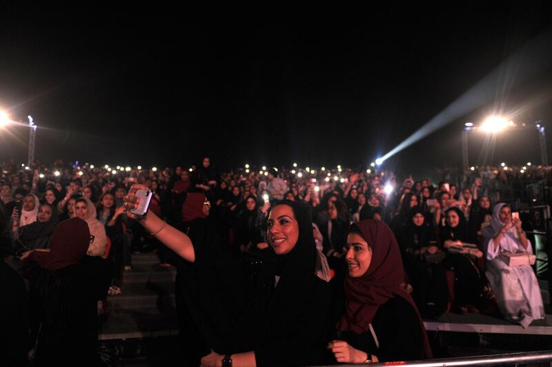 Saudi women take a selfie as they attend a concert by Egyptian pop sensation Tamer Hosny. Amer Hilabi / AFP