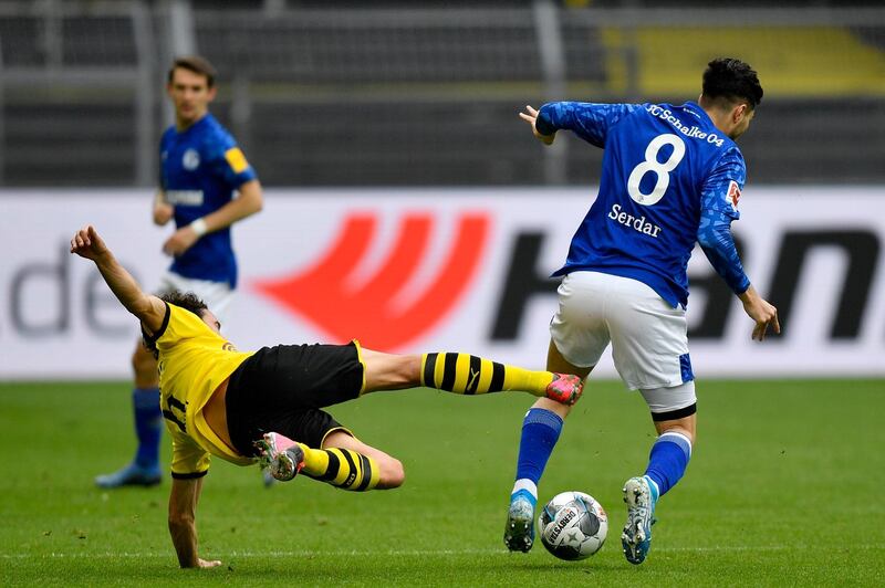Dortmund's Thomas Delaney challenges  Suat Serdar of Schalke. Getty