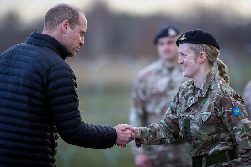 Prince William shakes hands with a soldier. EPA
