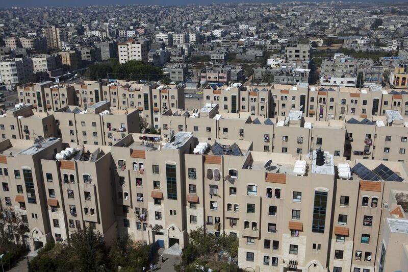 An overview showing part of Sheikh Zayed City against the skyline of the densely populated Gaza Strip which has a chronic housing shortage. Sheikh Zayed City was intended to be much bigger but further construction came to a halt after Hamas took over the territory in 2007 and Israel enforced a blockade. Heidi Levine for The National