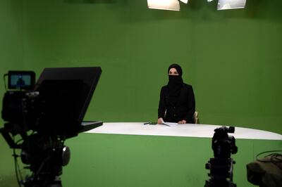 An Afghan female presenter at 1TV reads the news during a live broadcast in Kabul. AFP