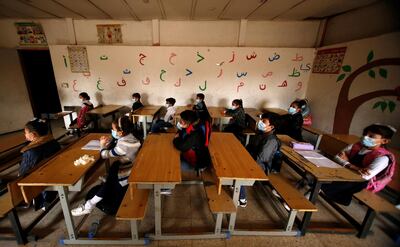 Students wearing protective face masks sit in a classroom following the reopening of their school, after months of closure due to the spread of the coronavirus disease (COVID-19), in Baghdad, Iraq November 29, 2020. REUTERS/Saba Kareem