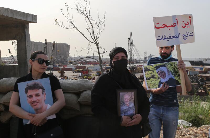 Families of the August 4 Beirut blast victims carry portraits of the deceased relatives as they stage a protest in the Lebanese capital. EPA