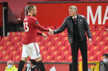Manchester United's manager Ole Gunnar Solskjaer, right, shakes the hand of Luke Shaw as he leaves the pitch during the match against Southampton on Monday. AP