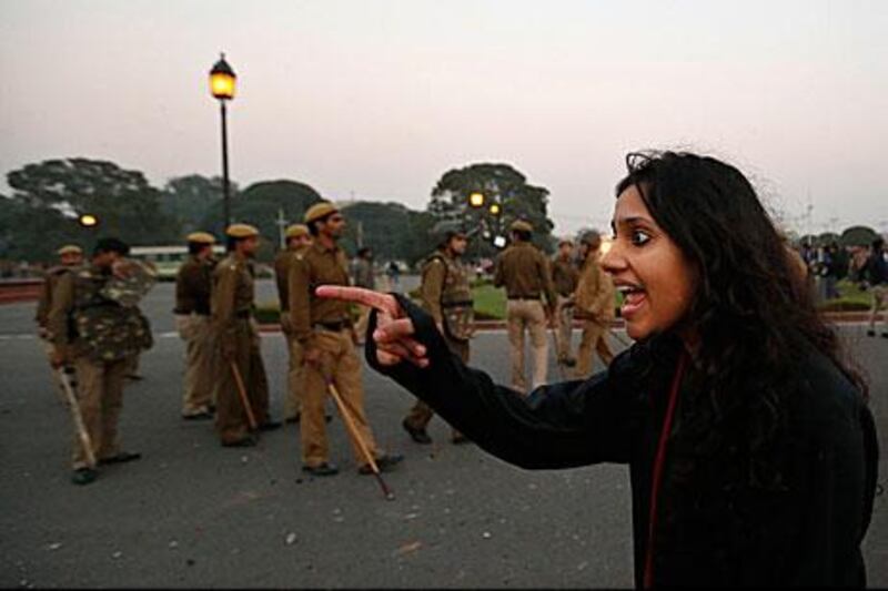 A protester points at police at a demonstration in New Delhi yesterday. Indian police have banned protests and marches against the violent gang-rape of a woman on a bus last week.