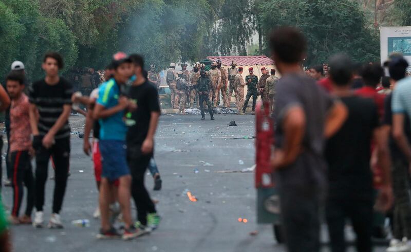 Iraqi security forces prevent anti-government protesters from going to the site of protests in Baghdad, Iraq. AP Photo