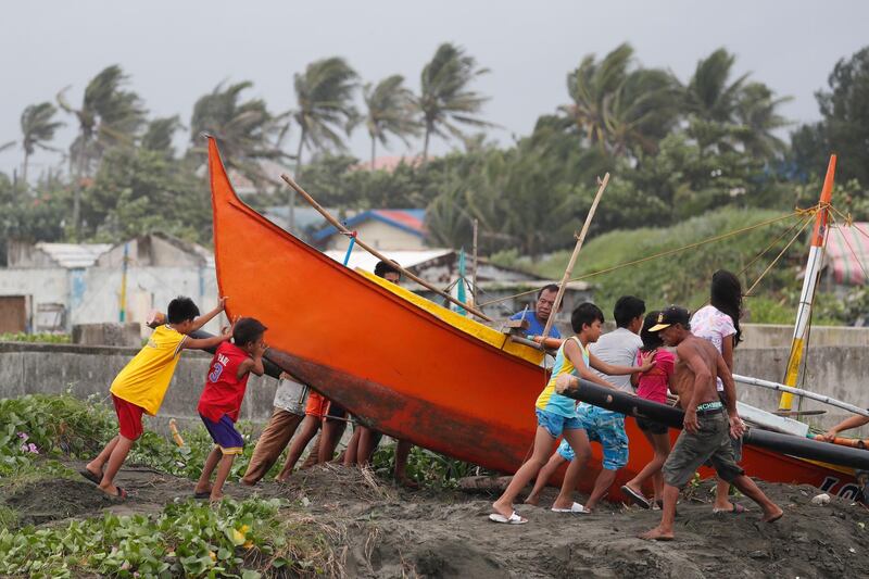 Filipino fishermen secure a boat in the town of Aparri, Cagayan province, Philippines.  Francis R. Malasig / EPA