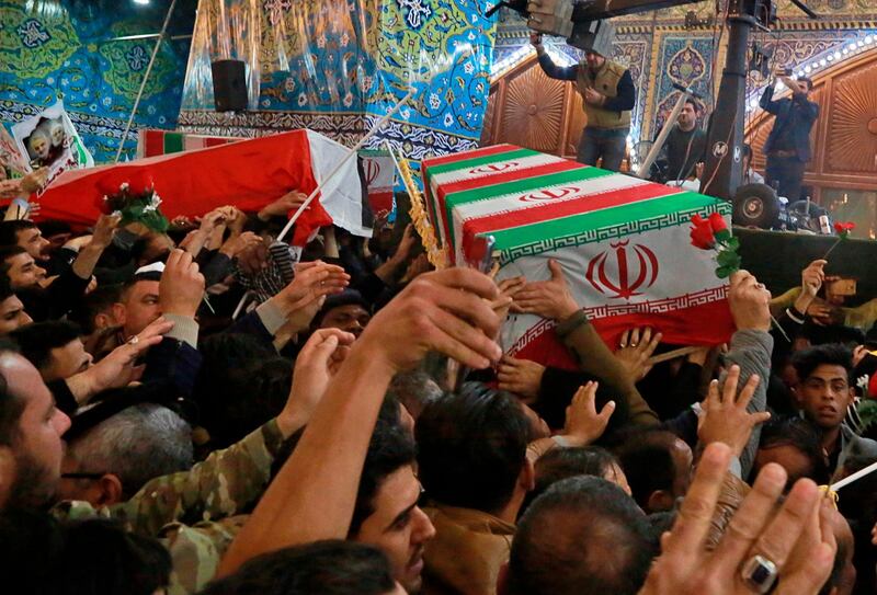 Mourners carry the coffins of Iran's top general Qassem Soleimani and Abu Mahdi al-Muhandis, deputy commander of Iran-backed militias in Iraq known as the Popular Mobilization Forces, during their funeral in the shrine of Imam Hussein in Karbala, Iraq, Saturday, Jan. 4, 2020. Iran has vowed "harsh retaliation" for the U.S. airstrike near Baghdad's airport that killed Tehran's top general and the architect of its interventions across the Middle East, as tensions soared in the wake of the targeted killing. (AP Photo/Khalid Mohammed)