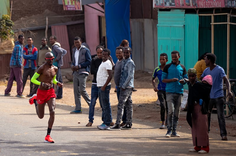 Farah has the support of locals during a 42km training run in February 2018 in Addis Ababa, Ethiopia. Getty Images